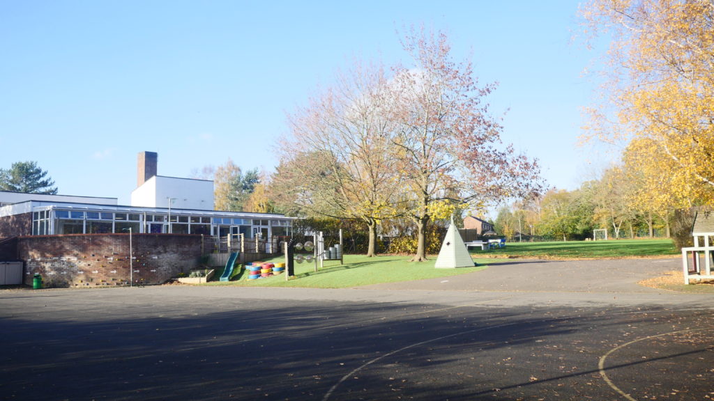 An external photo of the academy building and playground.