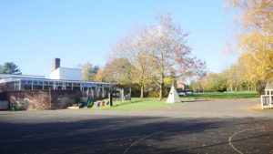 An external photo of the academy building and playground.