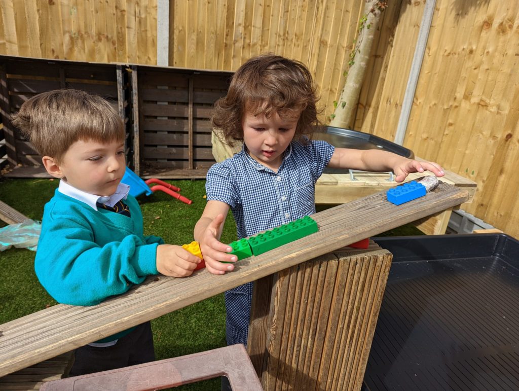 EYFS pupils are seen playing in and enjoying their new outdoor area on the academy grounds.