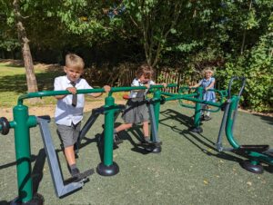 Some Horsmonden pupils can be seen using the outdoor Gym apparatus on the academy grounds and smiling for the camera.