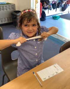 Children in Year 2 are seen experimenting with different materials to see which ones can change shape and why.