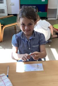 Children in Year 2 are seen experimenting with different materials to see which ones can change shape and why.