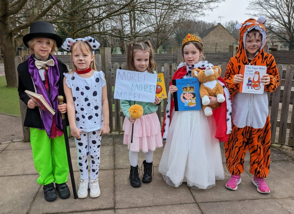 Students smiling for a photo in their World Book Day costumes