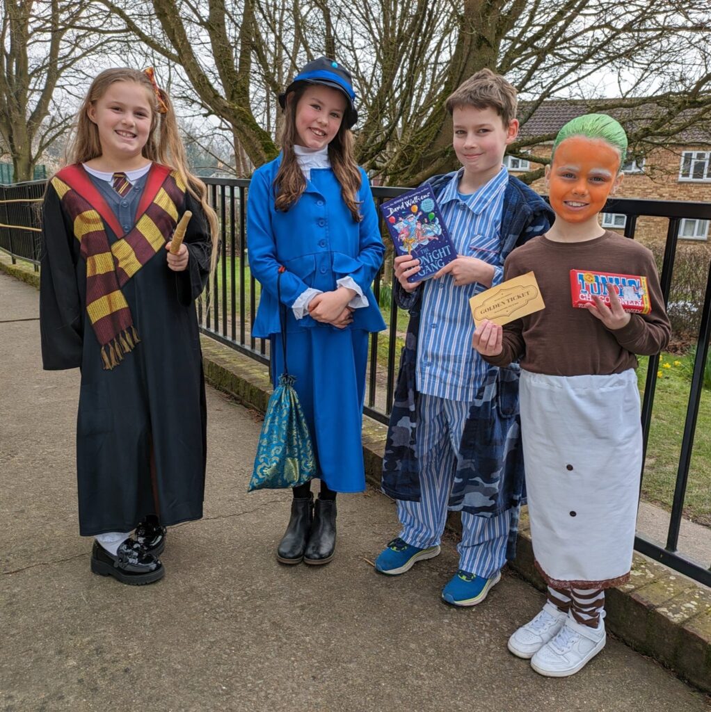 Four students are pictured dressed up as well-known characters from books for World Book Day 2024.