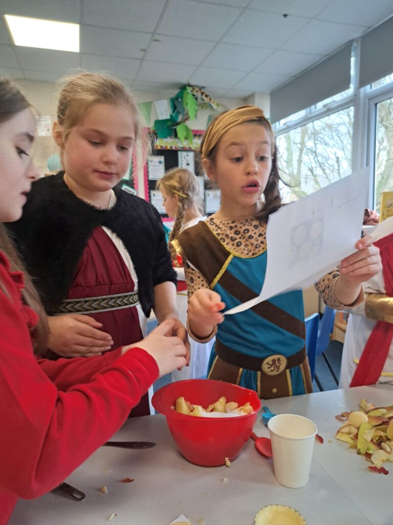 Students dressed as Romans following a recipe