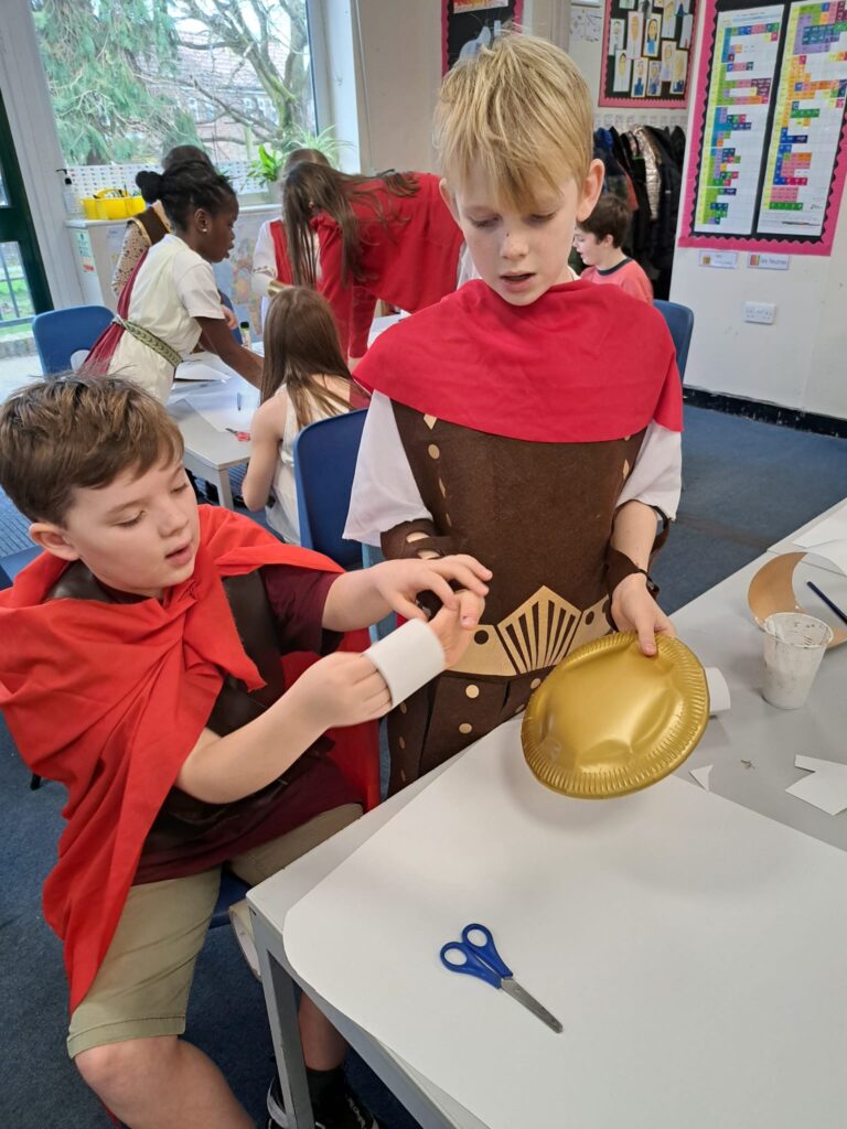 Students dressed as Romans working at a table
